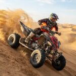 Agressive quad biking on sand dune