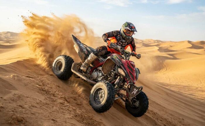 Agressive quad biking on sand dune