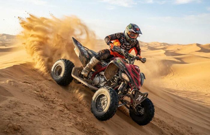 Agressive quad biking on sand dune