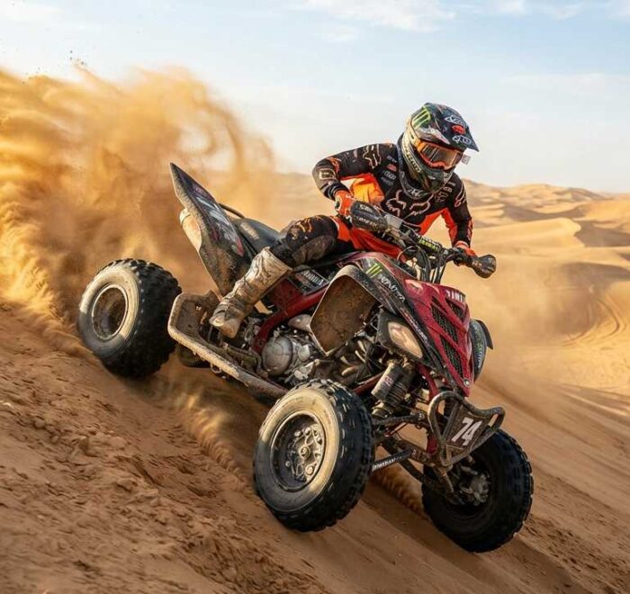 Agressive quad biking on sand dune